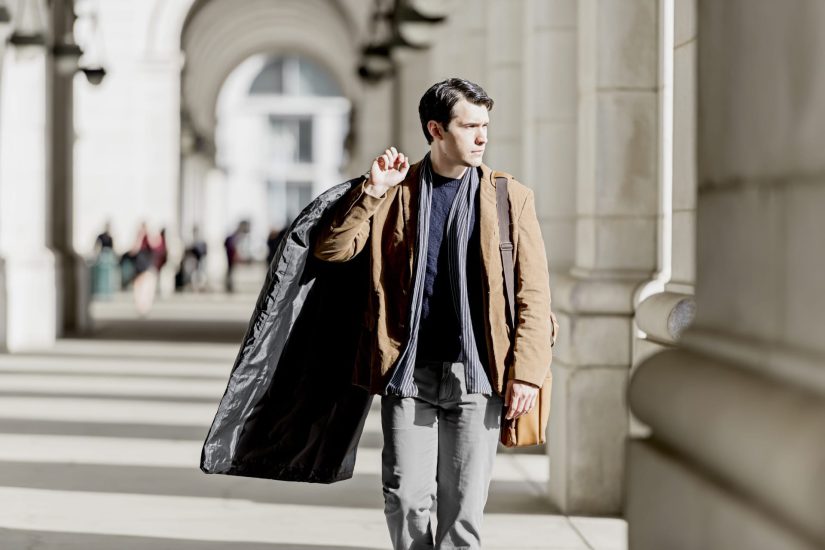 A man walking with his cleaned coat